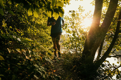 Full length of man running amidst plants