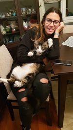 Young woman working with dog at home