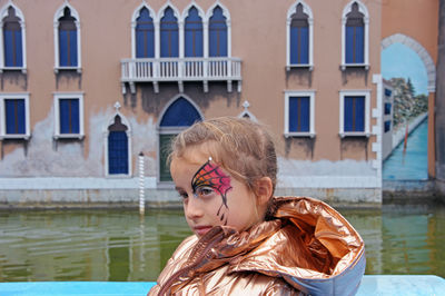 Portrait of woman against building