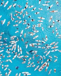 Directly above view of people in blue sea