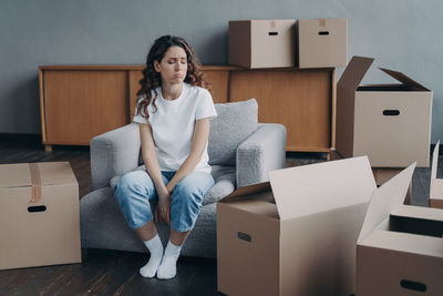 Portrait of woman sitting on sofa at home