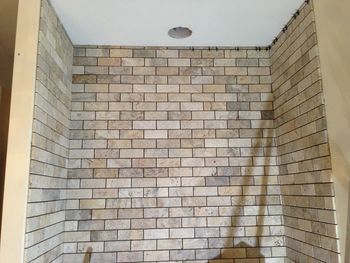 Low angle view of brick wall in building