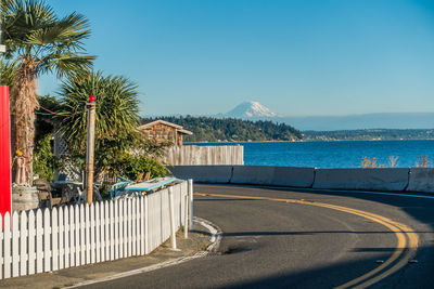 View of swimming pool by sea against clear sky