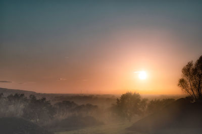 Scenic view of silhouette landscape against sky during sunset