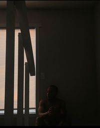 Man sitting by window at home