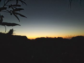 Silhouette of landscape against sky at sunset