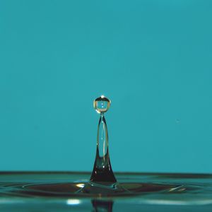 Close-up of water drop against blue background