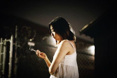 Rear view of woman standing in front of train