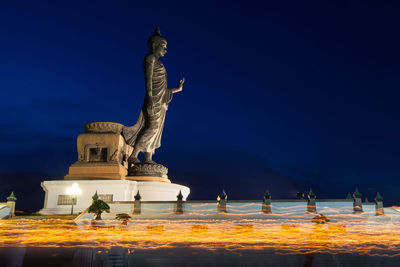 Statue of liberty against blue sky at night