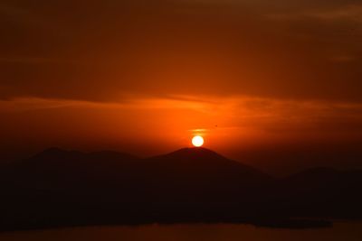 Scenic view of silhouette mountains against sky during sunset