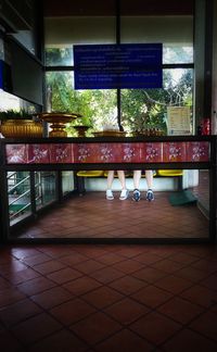 View of table and chairs in glass window