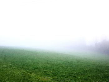 Scenic view of field against sky during foggy weather