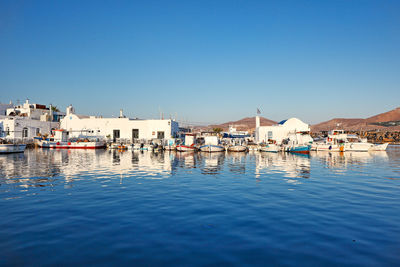 Buildings in town against clear blue sky