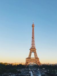 Communications tower in city against clear sky