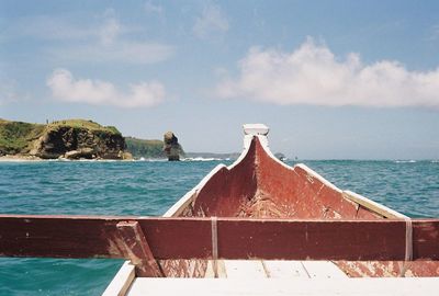 Cropped image of boat on sea against sky during sunny day