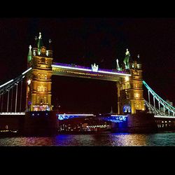 Illuminated bridge at night