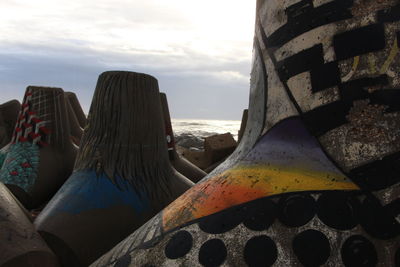 Close-up of abandoned boat at beach against sky