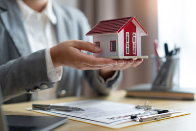 Insurance concept the property dealer presenting the new model of house to the customer.