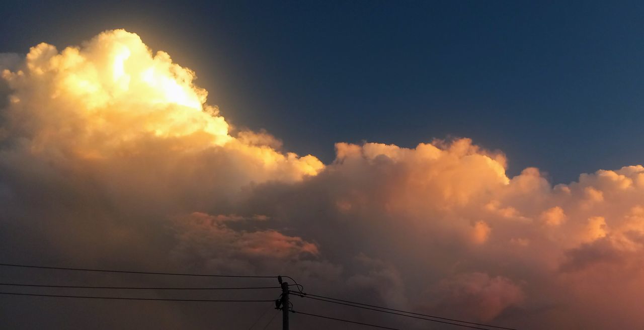 sky, cloud, electricity, cable, nature, sunset, afterglow, technology, beauty in nature, power supply, power line, dramatic sky, no people, sunlight, dusk, silhouette, outdoors, power generation, environment, electricity pylon, evening, cloudscape, scenics - nature, low angle view, orange color, communication, storm