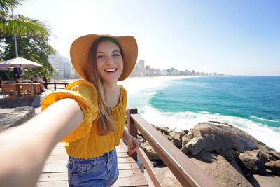 Brazilian young fashion woman takes selfie on leblon belvedere, rio de janeiro, brazil