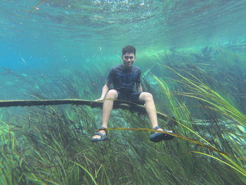 Full length portrait of man swimming in sea