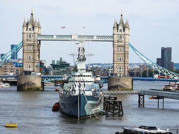 Boats in sea against cloudy sky