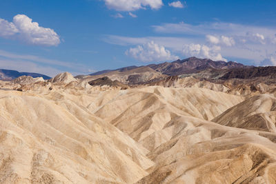 View of desert against cloudy sky