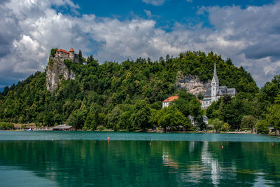 Scenic view of lake castle and village against sky