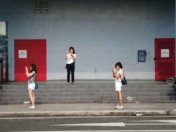 Full length of woman standing by railing