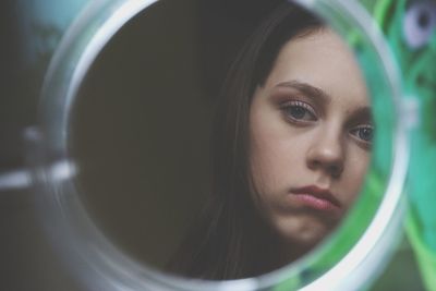 Young woman reflecting on mirror