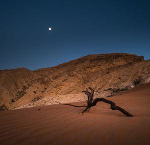 Scenic view of desert against clear sky at night