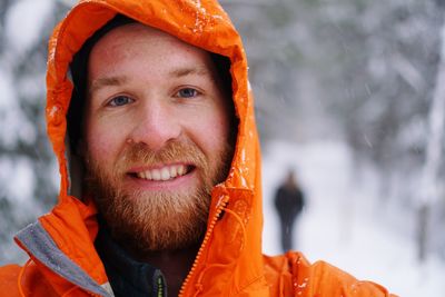 Portrait of smiling man in snow