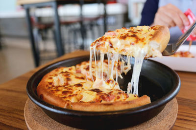 Close-up of pizza served on table