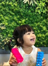 Cute girl holding toy blocks