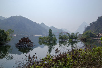 Scenic view of lake and mountains against clear sky