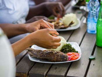 Close-up of hand holding food on table