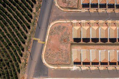 High angle  view of construction site of standardized houses surrounded by a coffee plantation.
