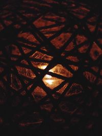 Close-up of metal fence at night