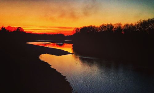 Scenic view of lake against sky during sunset