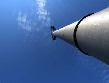 Low angle view of airplane against blue sky