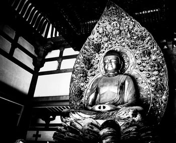 Low angle view of buddha statue in building