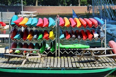 Colorful kayaks on shelf against river