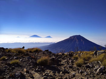 Scenic view of snowcapped mountain against blue sky