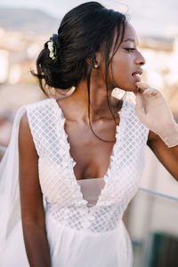 Portrait of bride looking away while standing outdoors