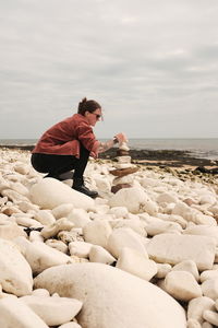 Rear view of woman standing at beach