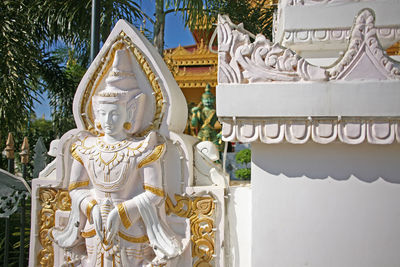 Statue of temple against building