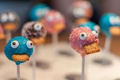 Close-up of anthropomorphic faces on lollipops on table