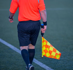 Low section of man playing soccer