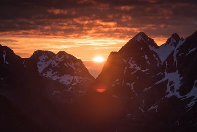 Scenic view of snow covered mountains during sunset