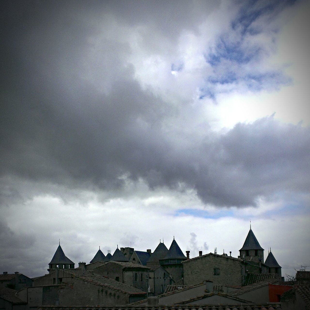 architecture, building exterior, built structure, sky, cloud - sky, cloudy, low angle view, weather, overcast, cloud, high section, roof, outdoors, house, building, no people, day, residential structure, storm cloud, place of worship